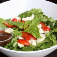 Caprese Salad · Fresh Mozzarella, Tomatoes, Basil, Olive Oil, and Balsamic Vinaigrette served on top of Lett...