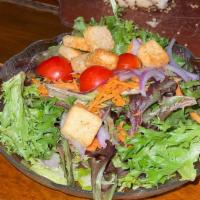 Field House Salad · Mixed greens, onion, tomato, carrots, artichoke hearts, hearts of palm, cheddar, and croutons.
