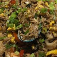 Chaufa Tres Sabores · Wok-fried rice, sautéed with shrimp, chicken, beef, chives, peppers, and egg.