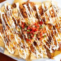 Nachos · Nachos with refried beans and melted cheese, pico de gallo and sour cream on the top.