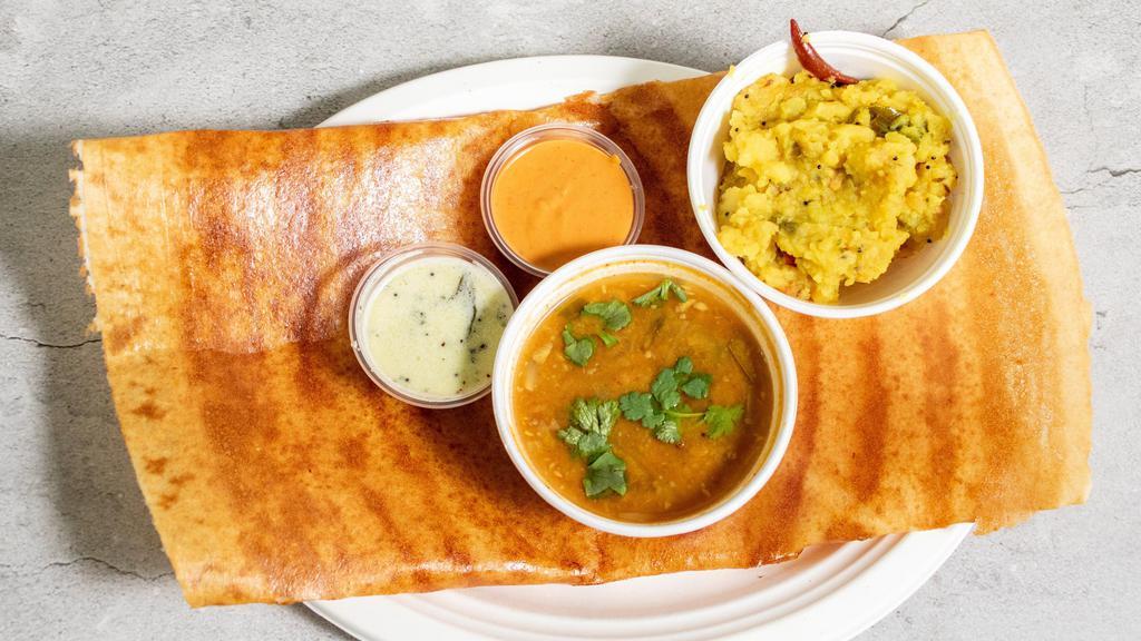 Andhra Kara Masala Dosa · A thin golden crispy rice and lentil flour crepe layered with special Andhra spicy chutney, stuffed with spiced potatoes masala served with sambar and chutney.