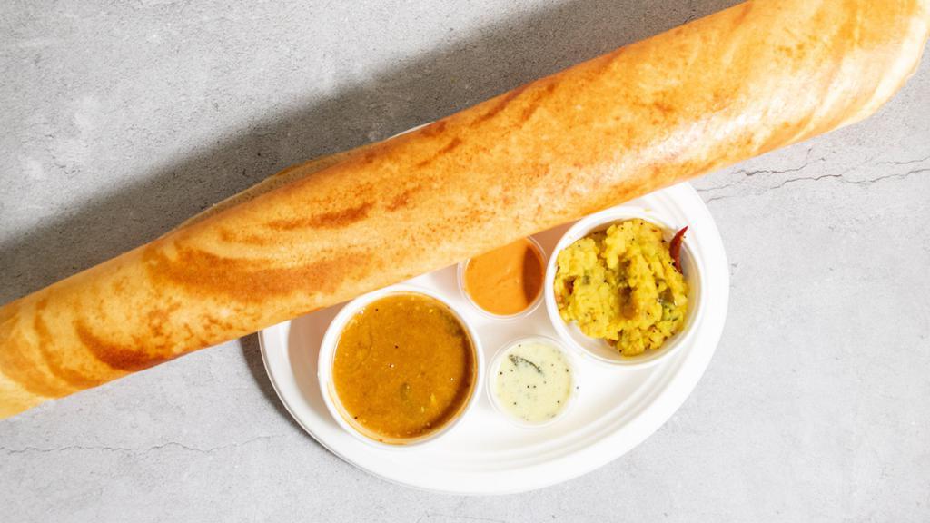 Paper Masala Dosa · Big size thin golden crispy rice and lentil flour crepe stuffed with spiced potatoes masala served with sambar and chutney.