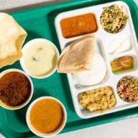 Veg Thali · Vegetarian Thali Served with 
Chapathi
Kurma
Rice
Sambar
Vegetable Kootu
Vegetable Poriyal
P...