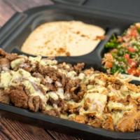 Shawarma Platter · Pita bread, beef, chicken, tabbouleh, hummus.