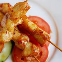 Chicken Satay · Chicken skewers marinated in thai spices and grilled to perfection, served with spicy peanut...