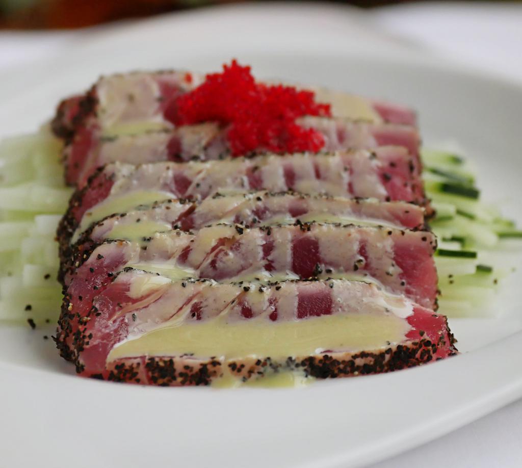 Tuna Cappaccio · Sliced black pepper tuna with House made honey wasabi sauce.
