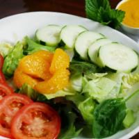 Garden Salad · Fresh mixed greens, tomato and cucumber with Sesame ginger dressing.