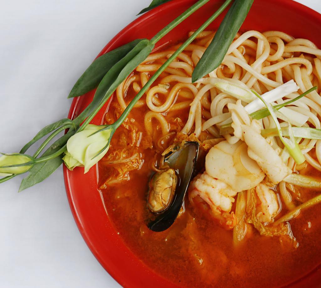 Korean Spicy Seafood Noodle Soup · Korean udon noodles, assorted seafood and seasoned vegetables in flavorful spicy broth.