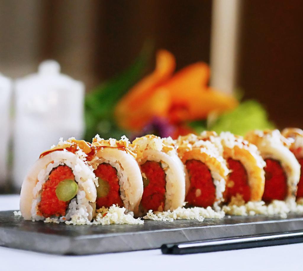 Super Crunchy Roll · Inside:spicy tuna and asparagus, outside: tuna, yellowtail, salmon, white tuna and tempura flakes, sauce: spicy mayo and eel sauce.