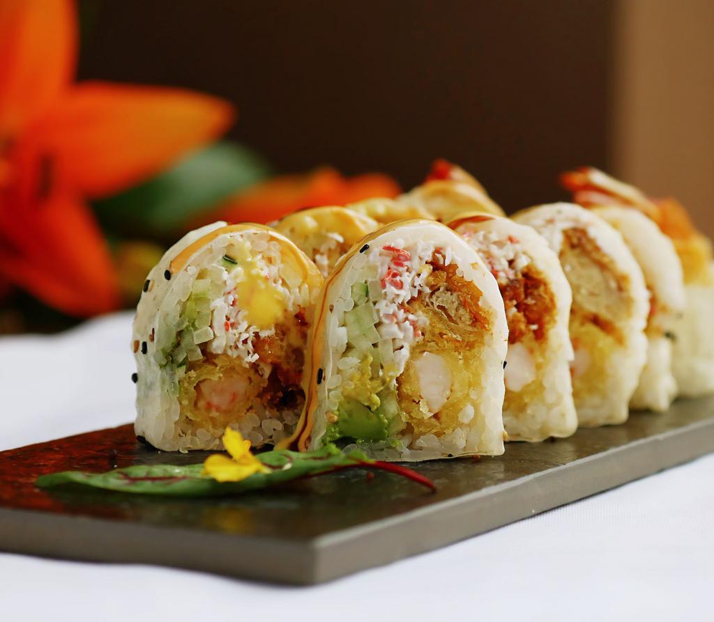 Lion Roll (10 Pc) · Soft shell crab, shrimp tempura, avocado, cucumber and crab salad wrapped in sesame soy paper, topped with eel sauce, spicy mayo and mango sauce.
