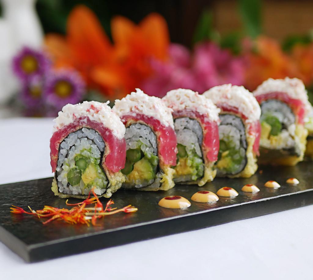 Eskimo Roll (6 Pc) · Cucumber, avocado and asparagus wrapped in nori seaweed, deep-fried, then topped with tuna, crab salad, eel sauce and spicy mayo.