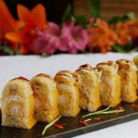 Banana Roll · Tempura shrimp and banana wrapped in soy paper, topped with tempura banana and eel sacue.
