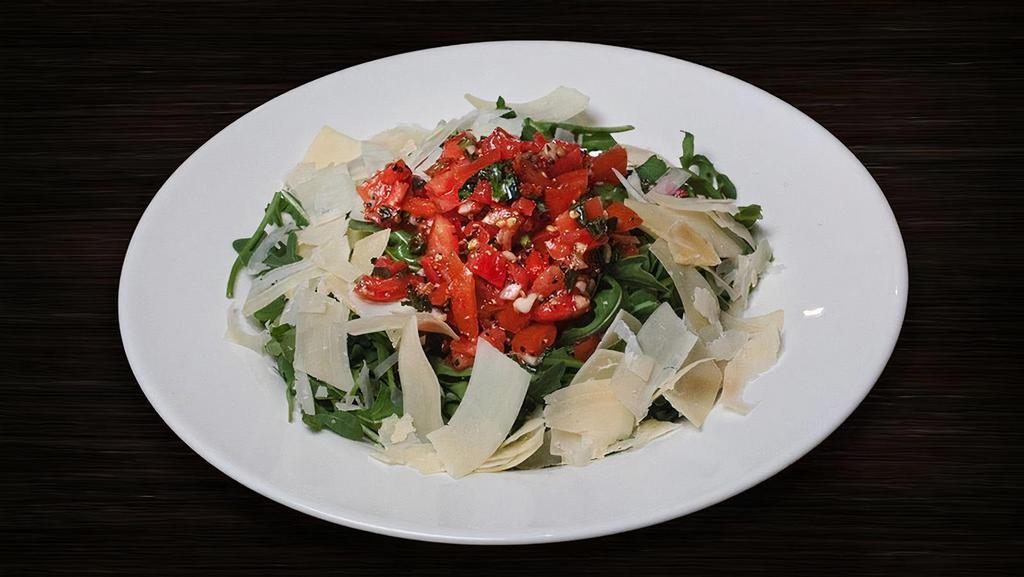 Arugula Salad (Tp) · Fresh arugula tossed in an Italian vinaigrette topped with bruschetta and shaved parmesan