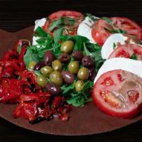 Caprese Primo Gusto  (Tp) · Fresh mozzarella & tomato (4 layers), roasted red peppers, marinated olives on a bed of arug...