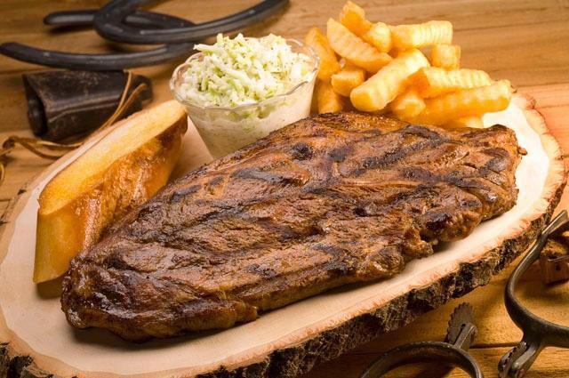 Pork Steak Plate. · Twin jumbo pork steaks, hand seasoned & fire-grilled over an open flame. Served with our famous coleslaw, French fries and garlic bread.