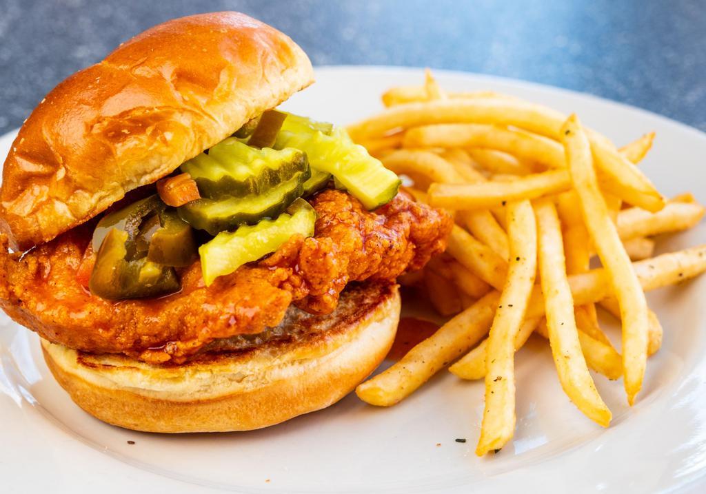 Nashville Hot & Spicy Chicken Sandwich · A marinated chicken breast, breaded and fried, tossed in a spicy honey sauce served on a roll with sweet pickle slices and jalapeno slices