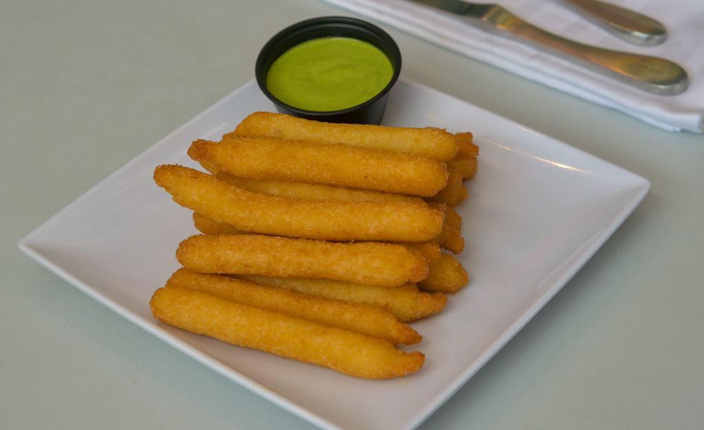Yuca Fries · Fried cassava sticks with homemade cilantro sauce.