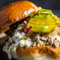 Da Clucker · Smoked chopped chicken, Alabama white BBQ sauce, caramelized onions, and B&B pickles.