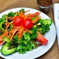 Baby Green Salad · Mixed baby greens, vine ripened tomatoes, and julienne carrots delicately seasoned with bals...