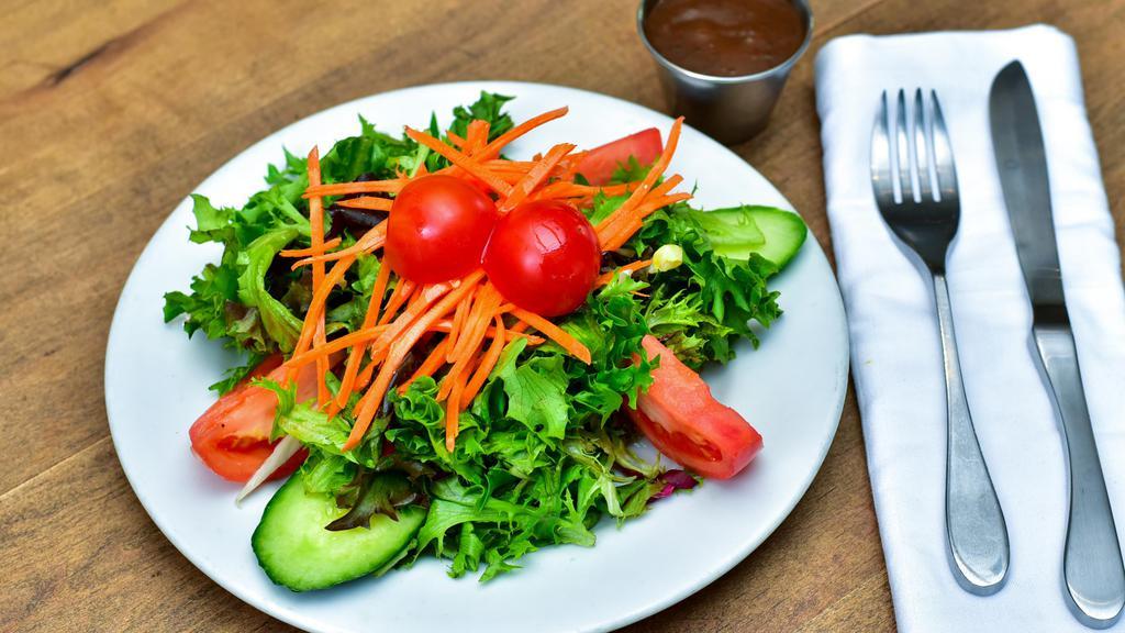 Baby Green Salad · Mixed baby greens, vine ripened tomatoes, and julienne carrots delicately seasoned with balsamic vinaigrette.