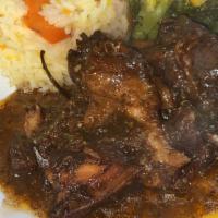 Brown Stew Chicken · Delicious chicken cooked down in tomato based gravy.