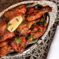 Tandoori Chicken · Spring chicken marinated in yogurt, garlic and ginger and then cooked in tandoor oven for pe...