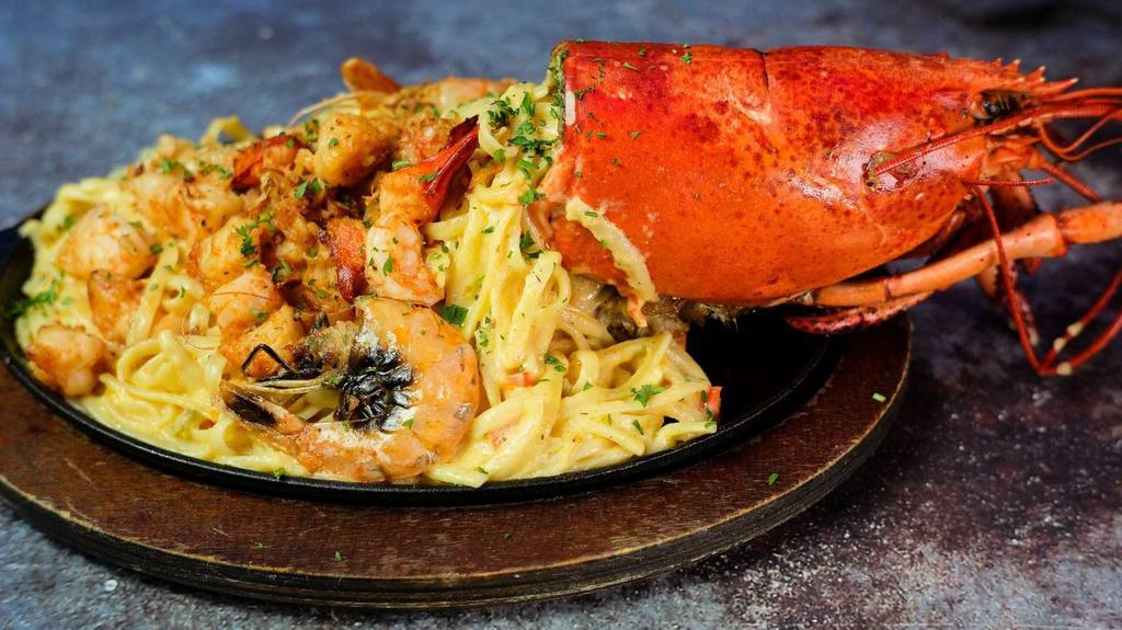 Lobster And Shrimp Thermidor · Lobster Shell Stuffed with Tender Lobster Served with Garlic Linguini and Finished with a Creamy Shrimp and Hennessey Cream Sauce.