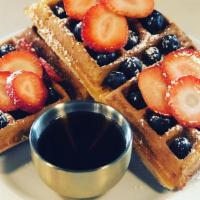 Classic Belgian Waffle (V) · A classic Belgian-style waffle topped with berries and served with maple syrup. *Vegan*