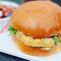 Crispy Chick'N Sandwich (V) · 2 chick'n tenders, “mozzarella”, herb aioli, pickled onions, and arugula on a brioche bun. *...