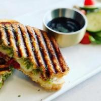 Pesto Grilled Cheese (V) · Mozzarella cheese, marinated sun-dried tomatoes, and a homemade pesto served with a balsamic...
