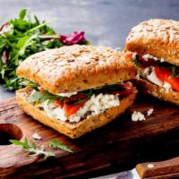 Famous Smoked Salmon Sandwich · Freshly cut smoked salmon mixed with cream cheese, red onions, capers sitting on toasted bre...