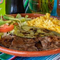Carne Asada Platillo · Grilled skirt meat served with rice, beans, salad, grilled cacti, and 4 corn tortillas.