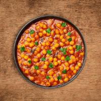 Savory Chickpeas Masala · Chickpeas and diced potatoes cooked in onion and tomato curry with Indian whole spices serve...