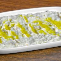 Baba Ghanoush (Mountabal) · Smashed grilled eggplant seasoned with sesame sauce and lemon juice. Includes pita bread.