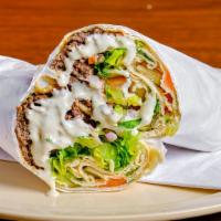 Beef Shawarma Wrap · Strips of slowly roasted marinated beef, hummus, lettuce, tomatoes, cucumber, cabbage salad ...