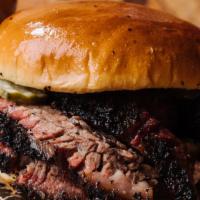 Beef Brisket Sandwich · Sliced or chopped certified angus beef brisket on a brioche bun with pickles. Includes chips...