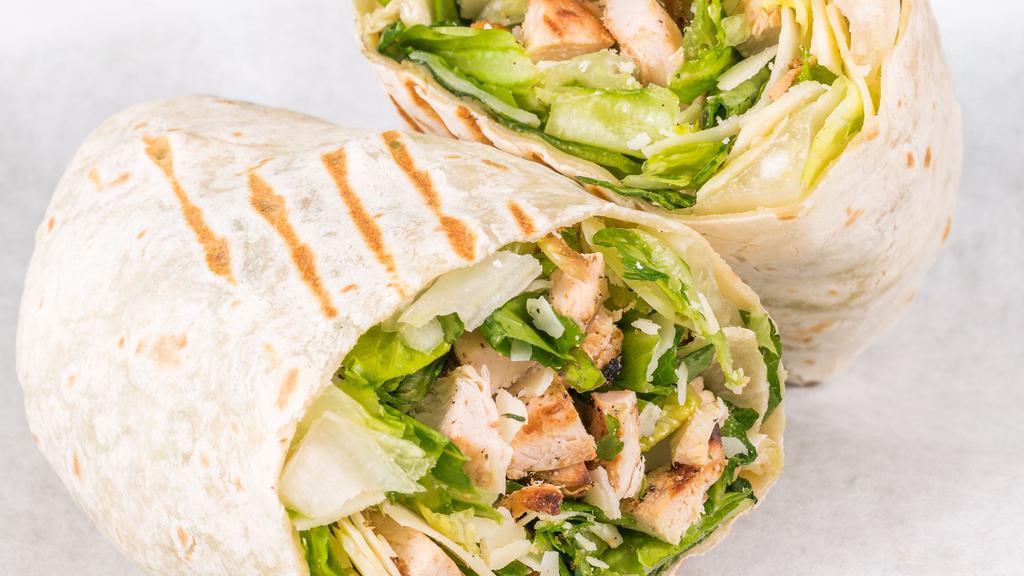 Chicken Caesar Wrap · Crisp romaine leaves, hormone-free chicken, parmesan cheese and crunchy croutons with caesar dressing served in a original wrap.