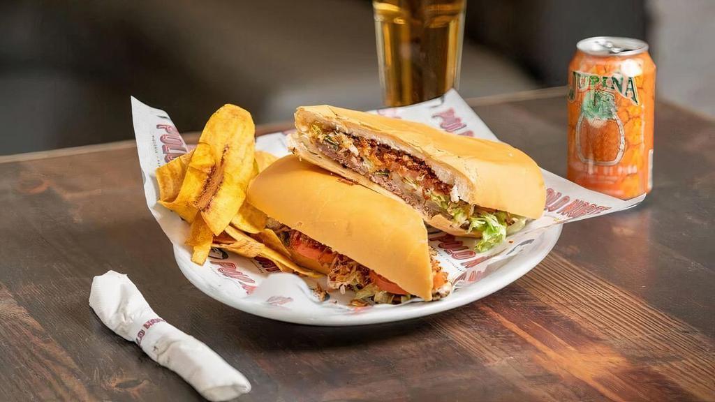 Pan Con Bistec Especial · Special Steak sandwich topped with ham, cheese, grilled onions, lettuce, tomatoes  and papitas julianas.