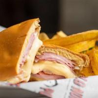 Media Noche · Ham, swiss cheese, pork, pickles and mustard on a sweet roll.
