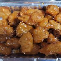 Honey Garlic Chicken · Battered and fried then glazed with honey garlic sauce topped with toasted sesame seeds.