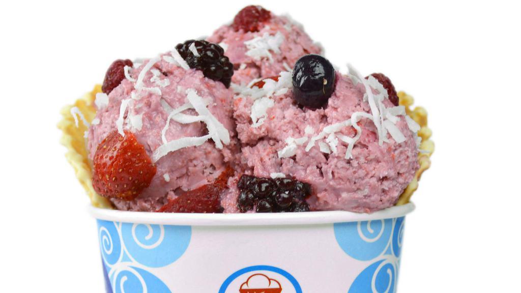 Tropical Turbine Ice Cream · Coconut and black raspberry ice cream with mixed berries and coconut flakes in a waffle bowl