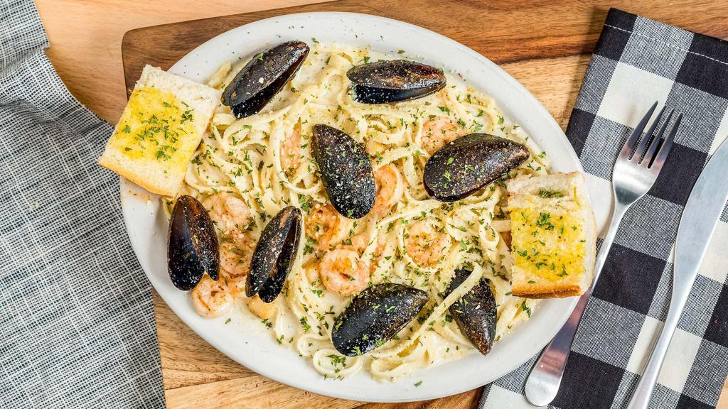 Seafood Alfredo · Served with salad and garlic bread. Mussels, scallops and shrimp in creamy Alfredo sauce.