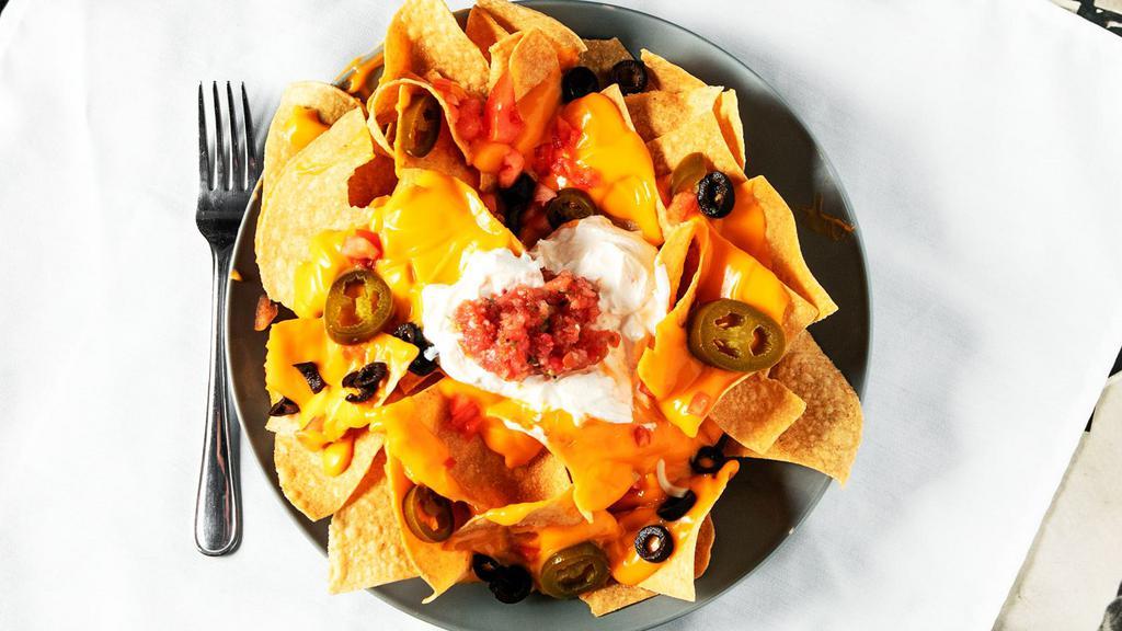 Nacho Mama'S Nachos · Tortilla chips piled with cheddar and jack cheeses, onions, black olives, tomatoes and jalapeños. Served with housemade salsa and sour cream. 655 cal.