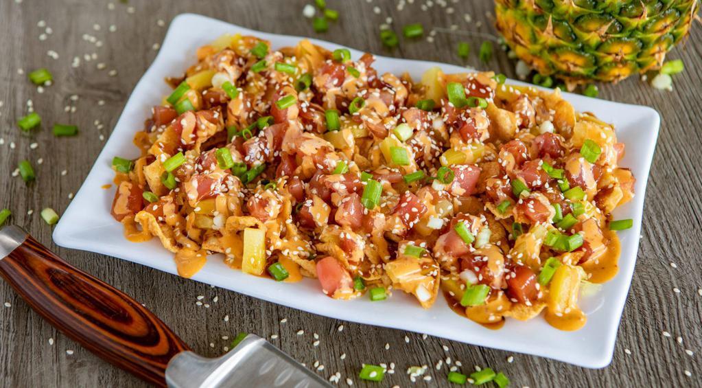 Ahi Poke Nachos · A plentiful plate loaded with crunchy wontons, marinated Ahi tuna, green onions, fresh pineapple & sesame seeds all topped off with our creamy Island Aioli. They’re a little spicy, a little tangy and TOTALLY amazing!