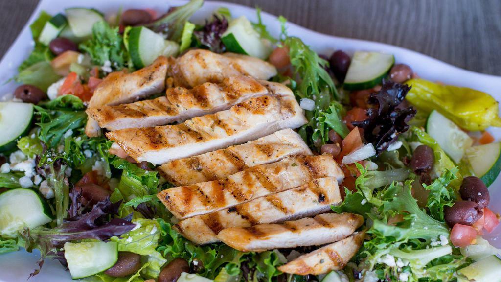 Greek Salad · House greens tossed together with fresh cherry tomatoes, tangy feta cheese, cucumbers, Kalamata olives, and diced onions. Then, it’s topped with a tender grilled chicken breast and served with pepperoncinis and a side of delicious Greek dressing.