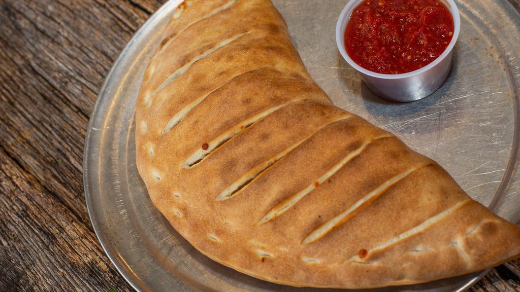Mediterranean Calzone · Spinach, artichoke hearts, olive oil, garlic, mozzarella, and roasted red peppers.