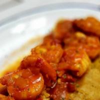 Tostones Con Camarones · Shrimp with garlic (Al Ajillo)  served over green plantains.