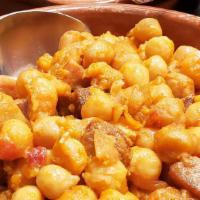 Garbanzo Frito · Chickpeas sautéed with chorizo, ham, bacon, peppers and onions.