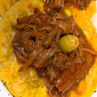 Tostones Con Ropa Vieja · Shredded sirloin cooked in Spanish creole sauce over green plantains. 3 Units.