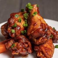 Jumbo Chicken Wings · Crispy fried chicken wings tossed in your choice of signature sauce served with carrots, cel...